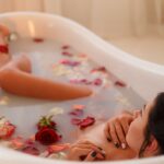 Home attractive girl takes a bath with milk and rose petals spa treatments for skin rejuvenation.jpg